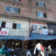 Garment factories sit above a food stall and a market in Dhaka. (July 2013)